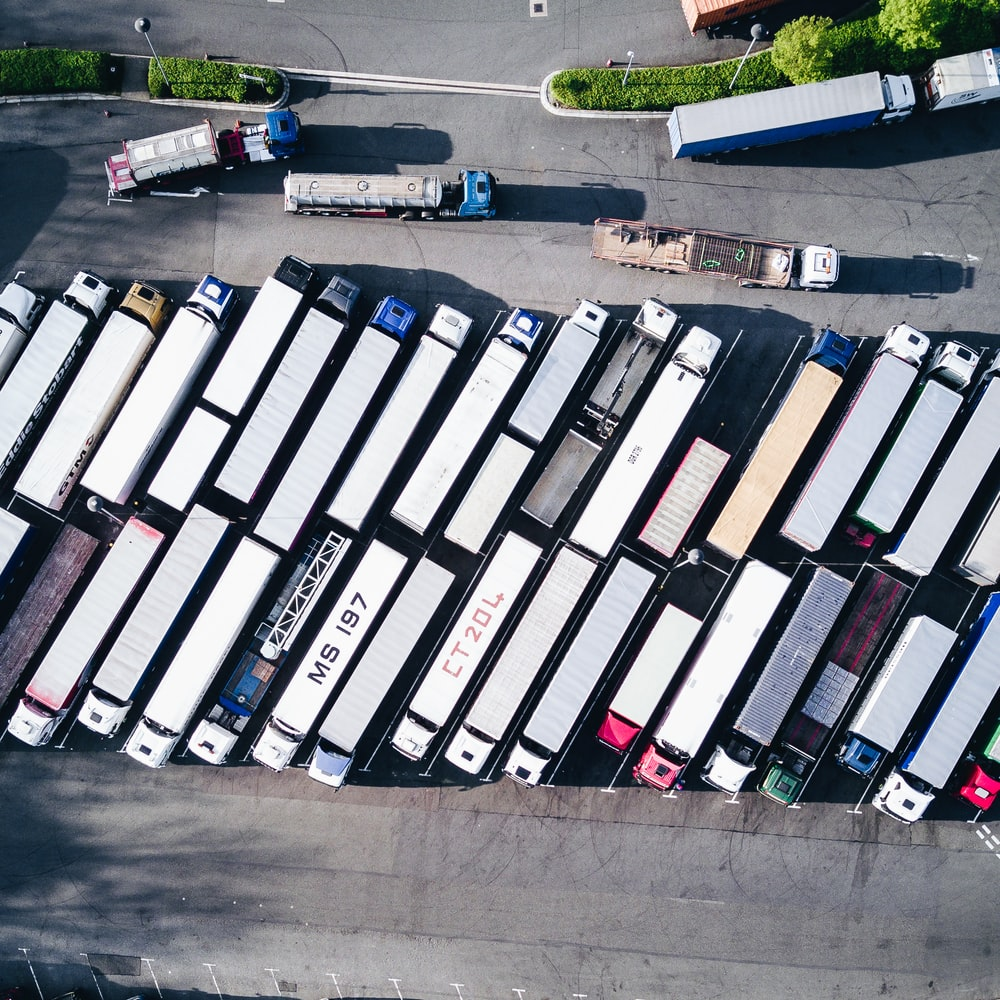Semi-trailer trucks parked next to one another